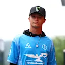 Lando camina por el paddock por delante del Gran Premio de Belga de 2025 con una camisa de estilo Jersey de su propio cuadrante de marca. Deslice para ver más