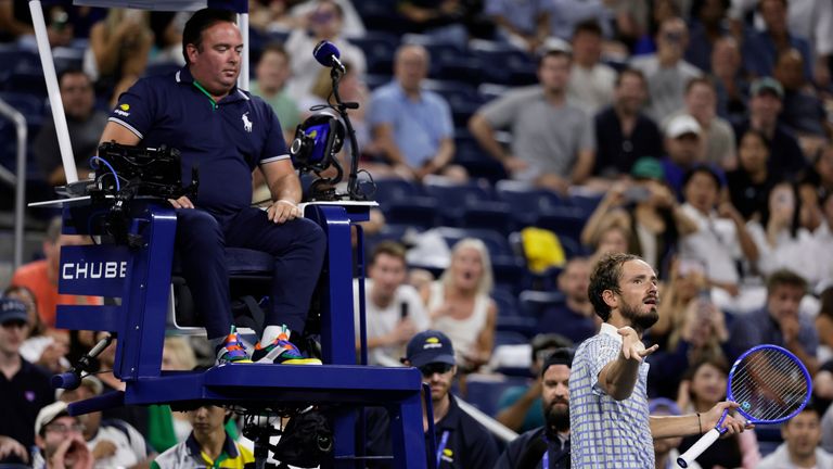 Daniil Medvedev, de Rusia, abajo a la derecha, reacciona junto al árbitro, Greg Allensworth, a la izquierda, después de que un fotógrafo corrió a la cancha Durin